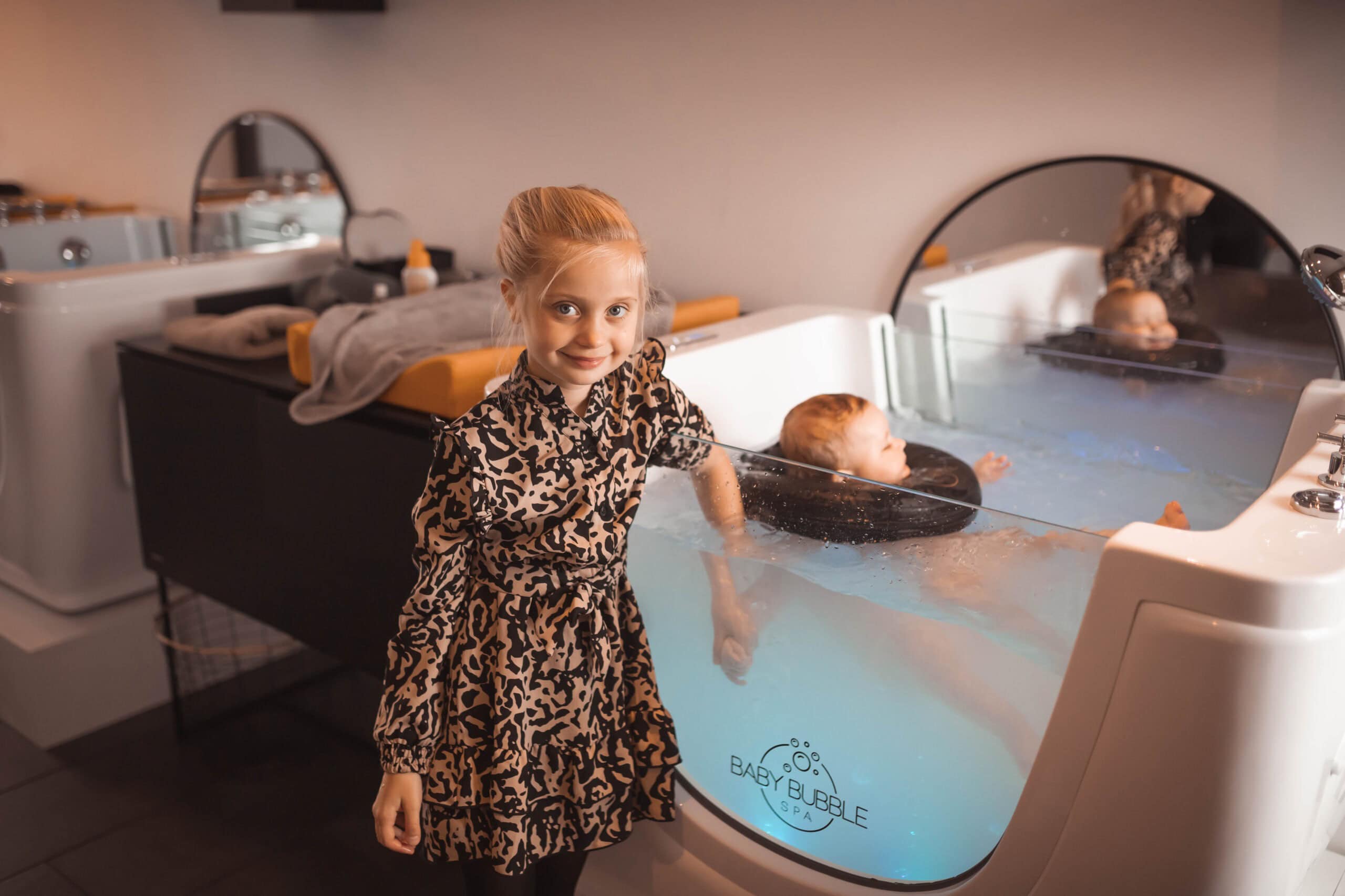 Kind in leopardprint jurk bij baby bubble spa in Groesbeek.